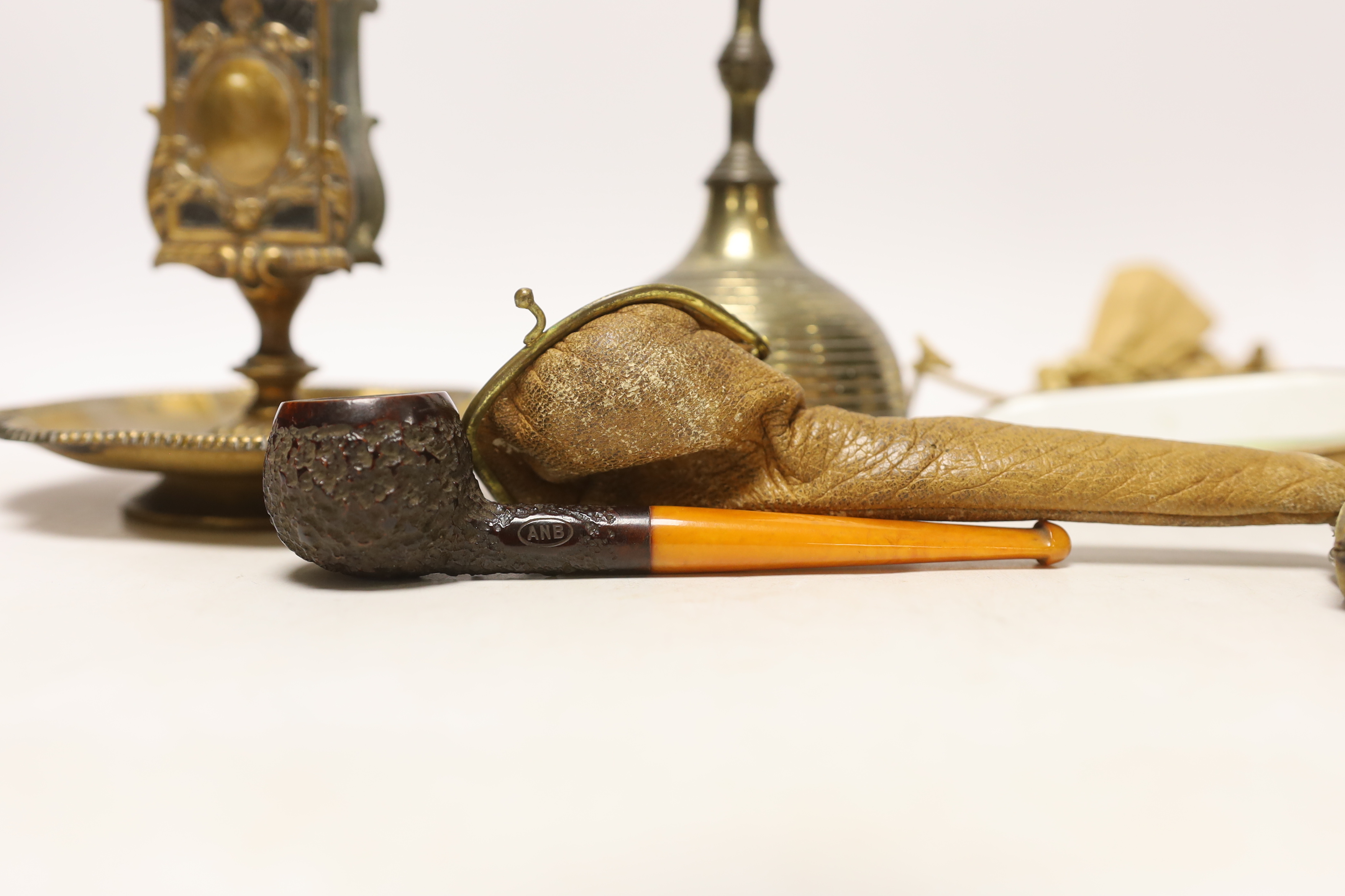 A group of collectables including a bell, a matchbox holder, a pendant, a brooch, etc.